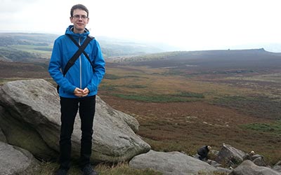 That's me in front of a great view of a valley located in the Peak District.