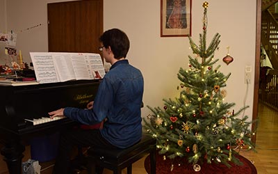 Time to play a Christmassy tune on our grand piano! I look forward to celebrating Christmas with my family.