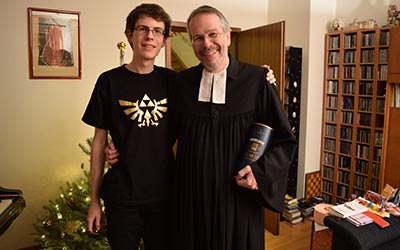 This is a lovely picture with my father after he returned from the Christmas service. I'm wearing my new T-Shirt with the epic Zelda symbol!